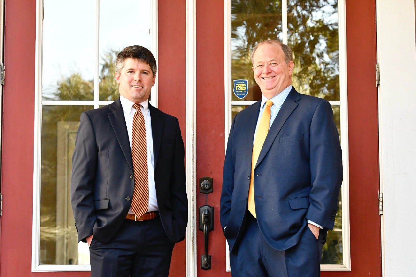 J. Olin McDougall, II and Clinton Redfern in front of an office building with a red door