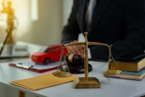 Car Accident Attorney with Scale and Toy Car