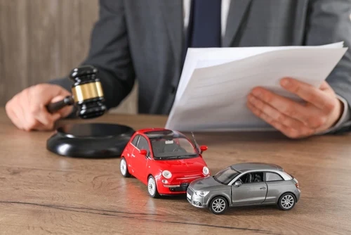 South Carolina car accident lawyer with a judge’s gavel and toy cars.