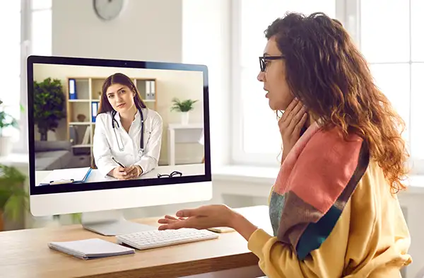 Woman with whiplash seeing virtual doctor