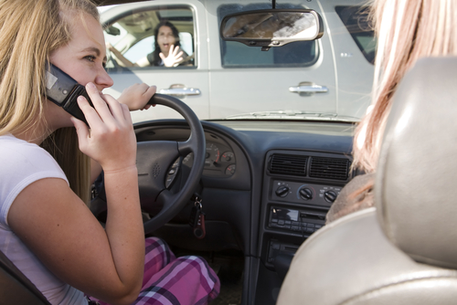 Two distracted drivers on their phones moments before a T-bone crash – example for a distracted driving accident lawyer