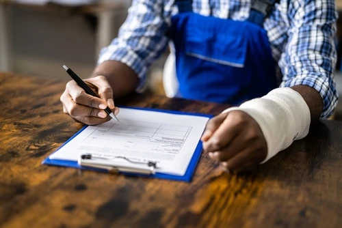 A man with a work injury claim form needs a workers compensation lawyer.