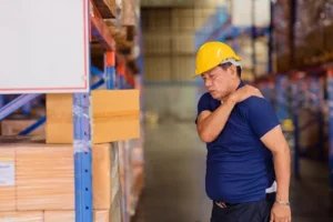 Warehouse worker experiencing shoulder pain after an injury and now seeking help from a Workers Compensation Lawyer.