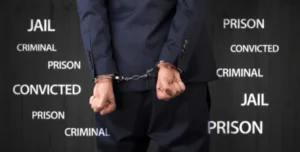 Man in handcuffs surrounded by DUI penalty icons — symbolizing the serious legal consequences of drunk driving and the defense provided by a Beaufort DUI accident lawyer.