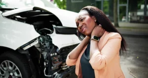 A woman experiencing neck pain after a personal injury and now seeking help form a personal injury lawyer