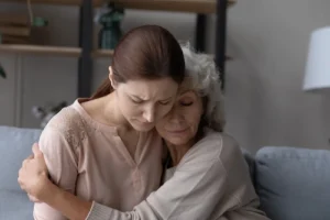 Two woman grieving the lost of a family member who experienced a wrongful death and they are now seeking a wrongful death lawyer to file a lawsuit.