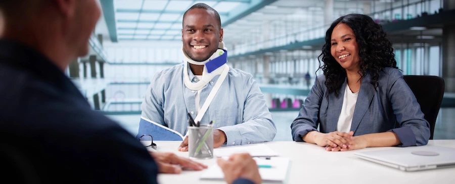 Two clients are speaking with a personal injury lawyer.