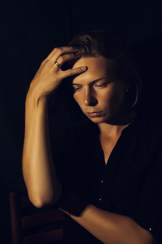 Person experiencing headache symptoms after a car accident
