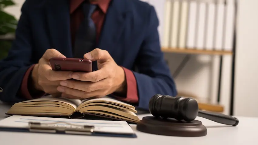 A lawyer looking through a phone as part of a social media addiction lawsuit.