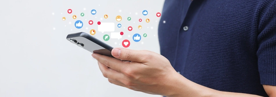 A person holding their phone on social media represents a family member filing a social media addiction lawsuit for another family member dealing with social media addiction.