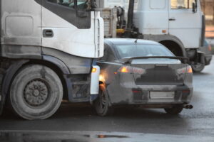 A tractor-trailer hits a car in a truck accident.