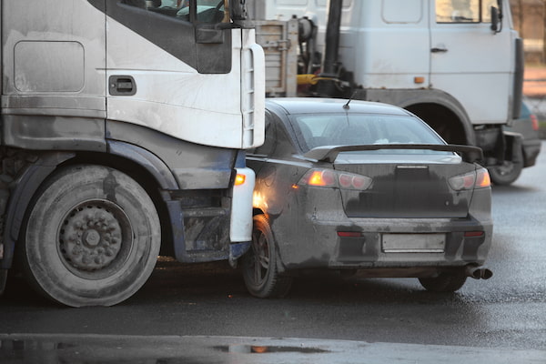 A tractor-trailer hits a car in a truck accident.